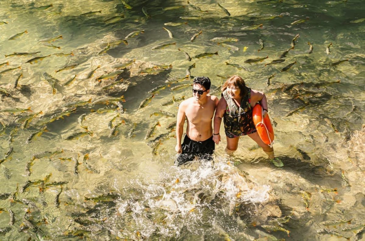 Couple,Of,Tourists,On,The,Transparent,Water,Of,A,River